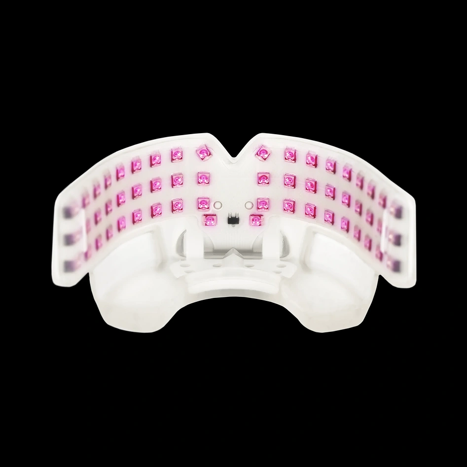 White ergonomic keyboard with pink keys, curved design, viewed from above on black background.