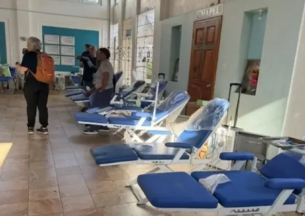 Dental clinic interior with multiple treatment chairs and staff during a mission trip in Jamaica.